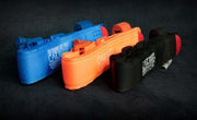 Blue, orange, and black CAT tourniquets for tactical first aid training, marked 'FOR TRAINING USE ONLY'